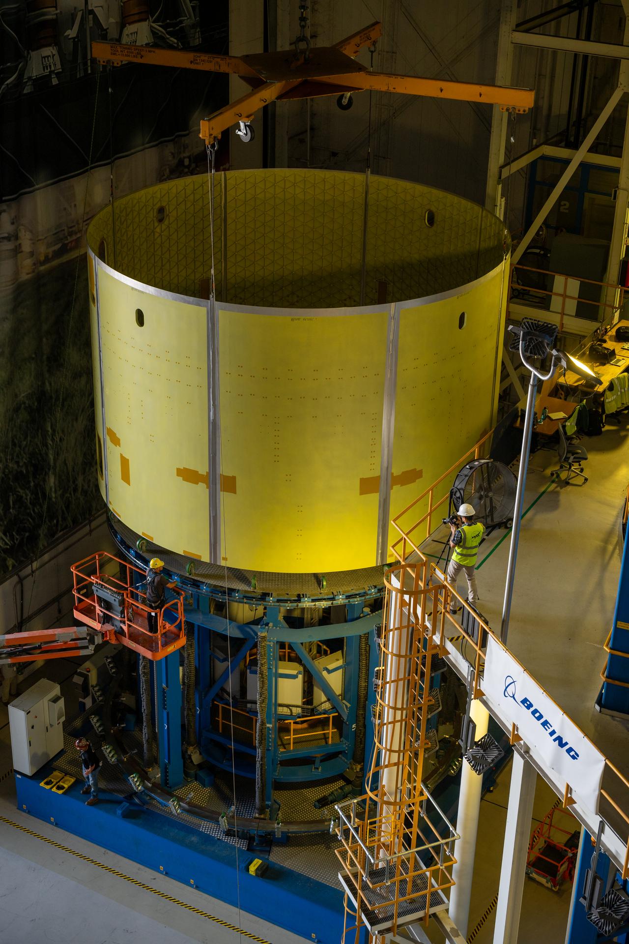 Teams at Michoud Assembly Facility in New Orleans load the engine section barrel into the vertical assembly center on Aug. 5, 2026. The engine section will be used on the SLS (Space Launch System) rocket’s core stage for the agency’s Artemis V mission. On the vertical assembly center tooling, teams will mate the flight hardware to a ring, which will serve as an attachment point for the liquid hydrogen tank later in the production process. The engine section is one of five major elements that make up the 212-foot-tall SLS rocket stage; and houses various avionic systems, the engine thrust structure, and four RS-25 engines. The core stage produces more than two million pounds of thrust to help launch NASA’s Orion spacecraft, astronauts, and supplies beyond Earth’s orbit and to the lunar surface for Artemis.